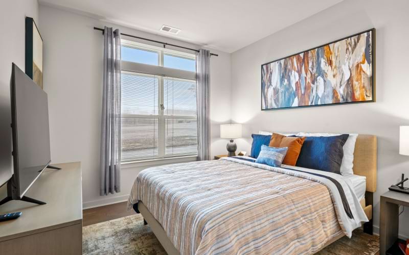 a bedroom with a large window