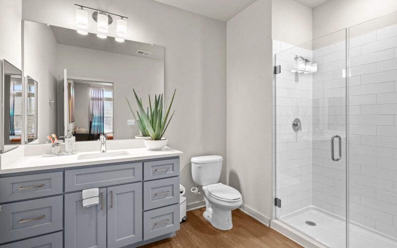 a spacious bathroom with a large mirror and ample light