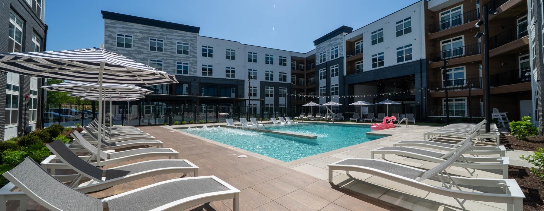 a pool with lounge chairs around it
