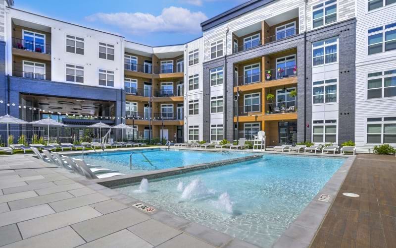 Resort-style swimming pool with lounge seating