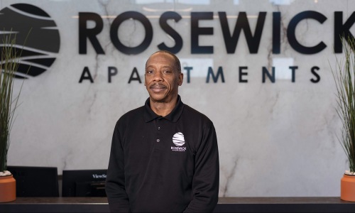 a person posing for a picture in front of a reception desk