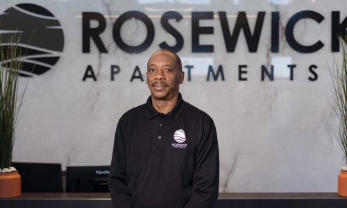 a person posing for a picture in front of a reception desk