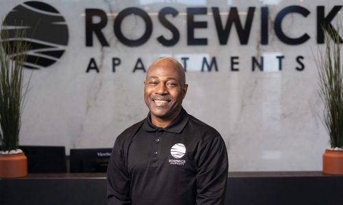 a person posing for a picture in front of a reception desk