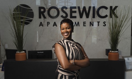 a person posing for a picture in front of a reception desk