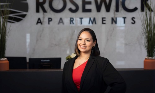 a person posing for a picture in front of a reception desk