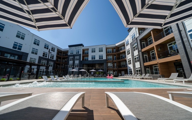 Resort-style swimming pool with lounge seating