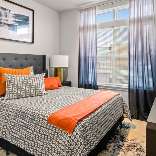 a bedroom with a bed and a desk