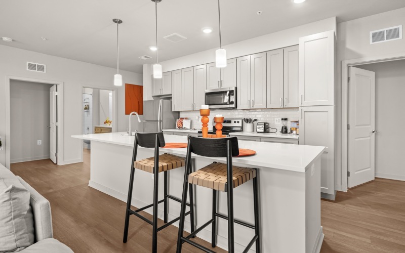 a kitchen with gray cabinets and a large island